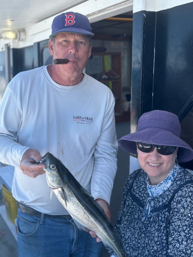 a man holding a fish