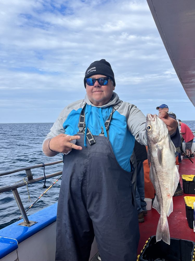 a person holding a fish in the water