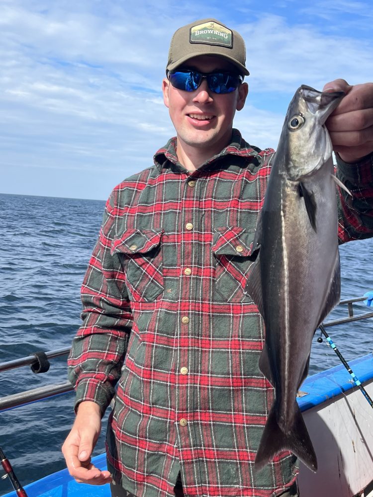 a man holding a fish in the water