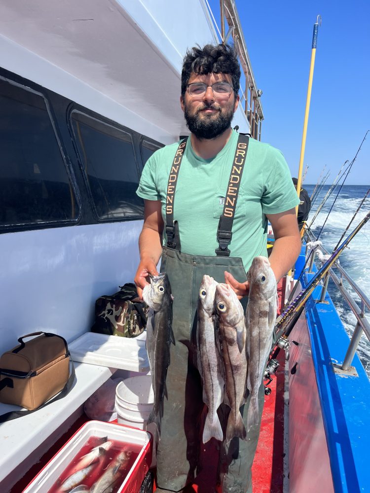 a person holding a fish on a boat