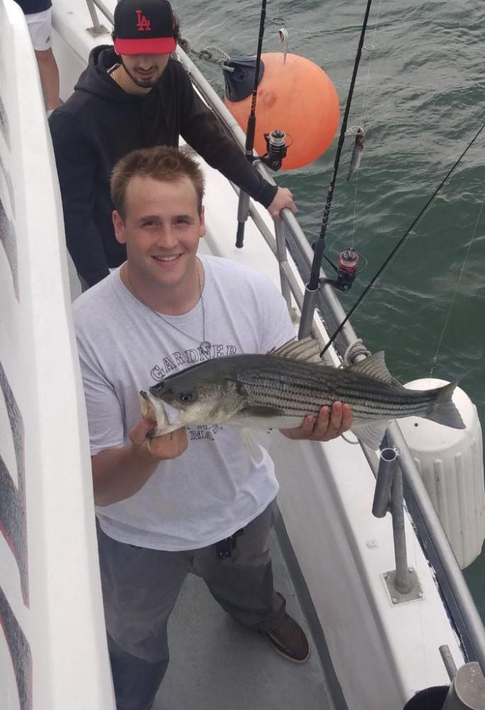 a man holding a fish in the water