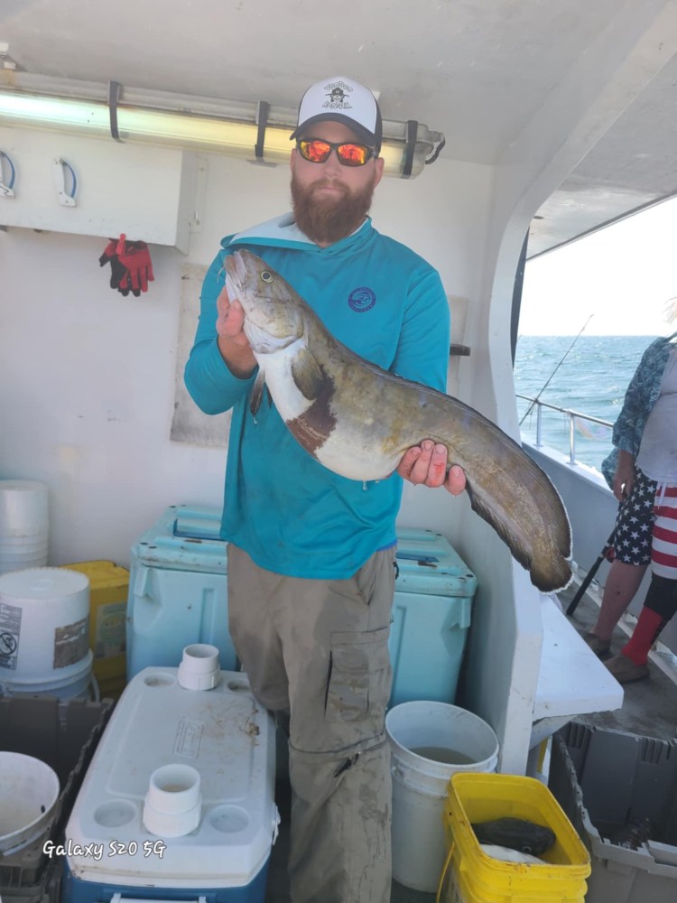 a man holding a fish