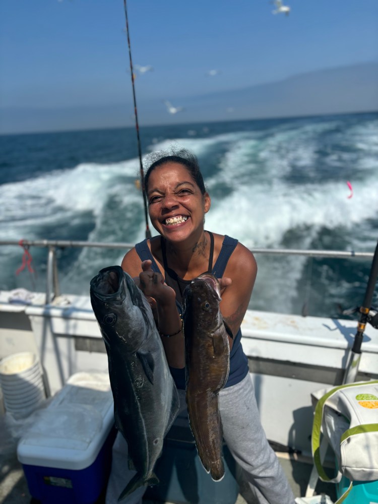 a person holding a fish in the water