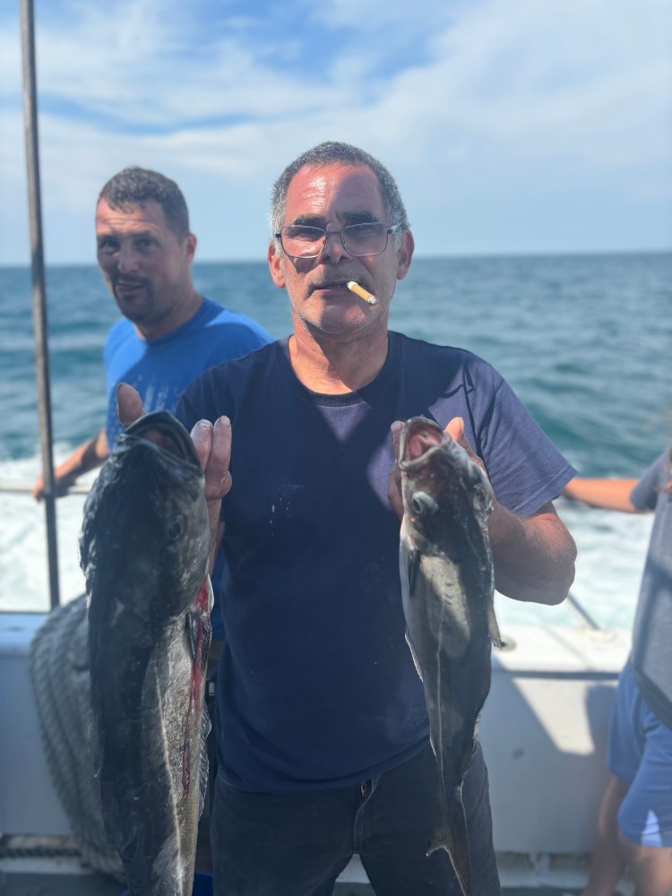 a man holding a fish in the water