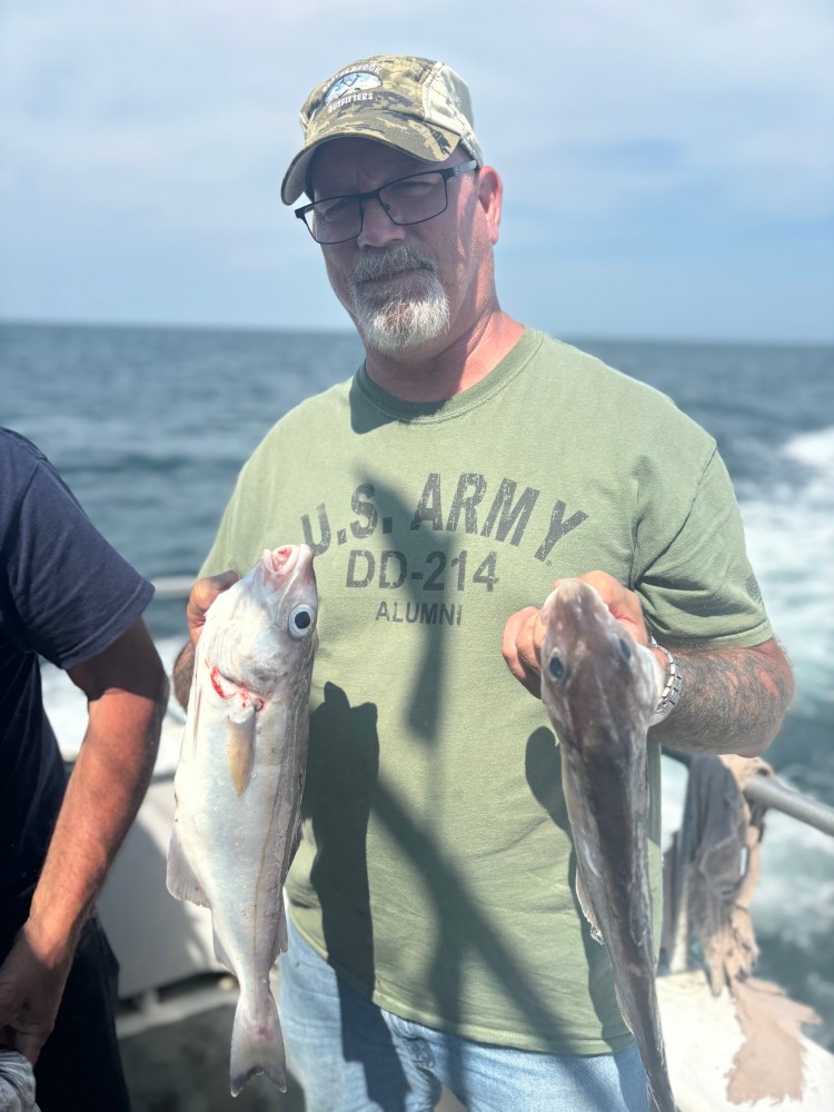 a man holding a fish in the water