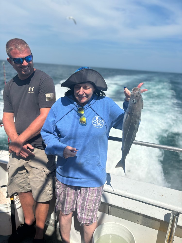 a person holding a fish in the water