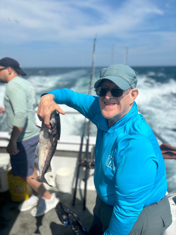 a man holding a fish