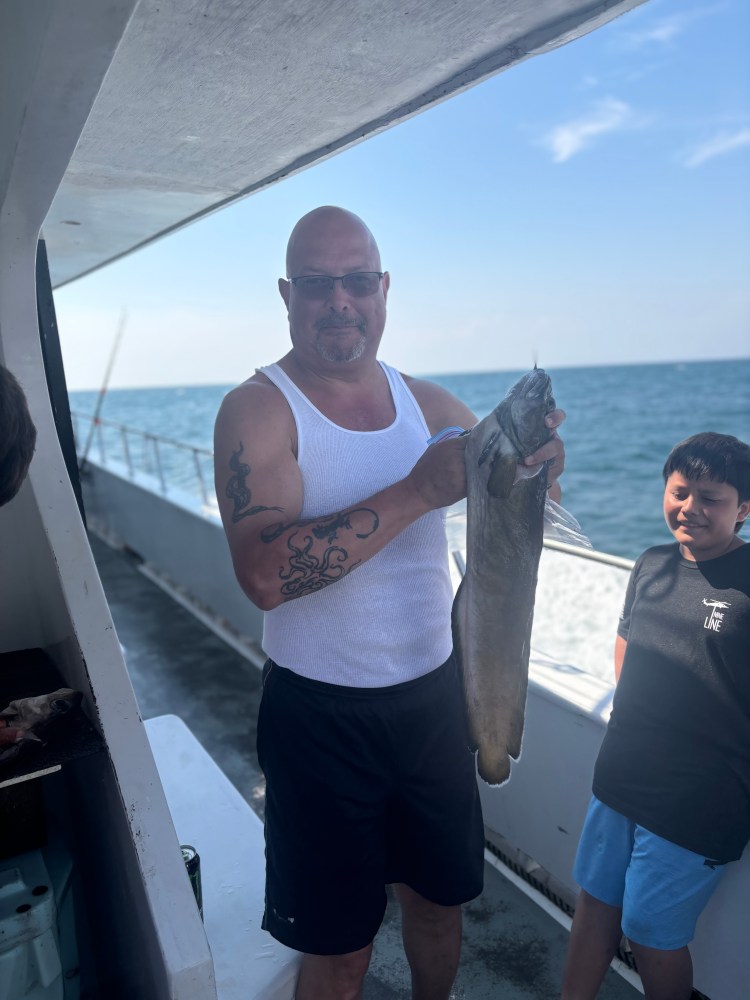 a man holding a fish in the water