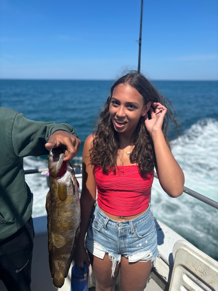 a person holding a fish in the water