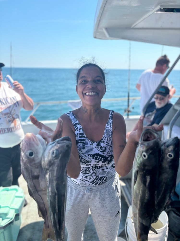 a person holding a fish in the water