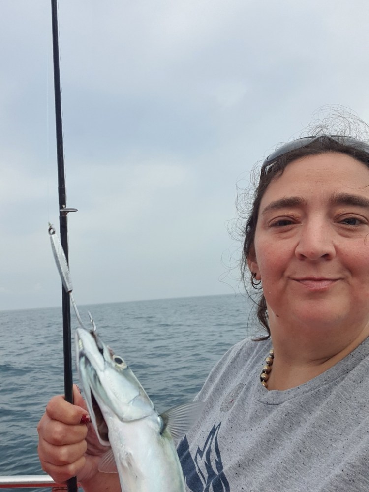 a person holding a fish in the water