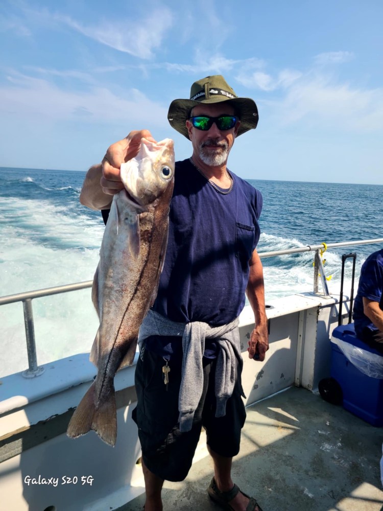 a person holding a fish in the water