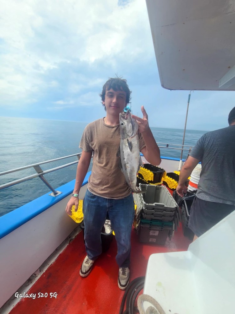 a man standing on a boat in the water