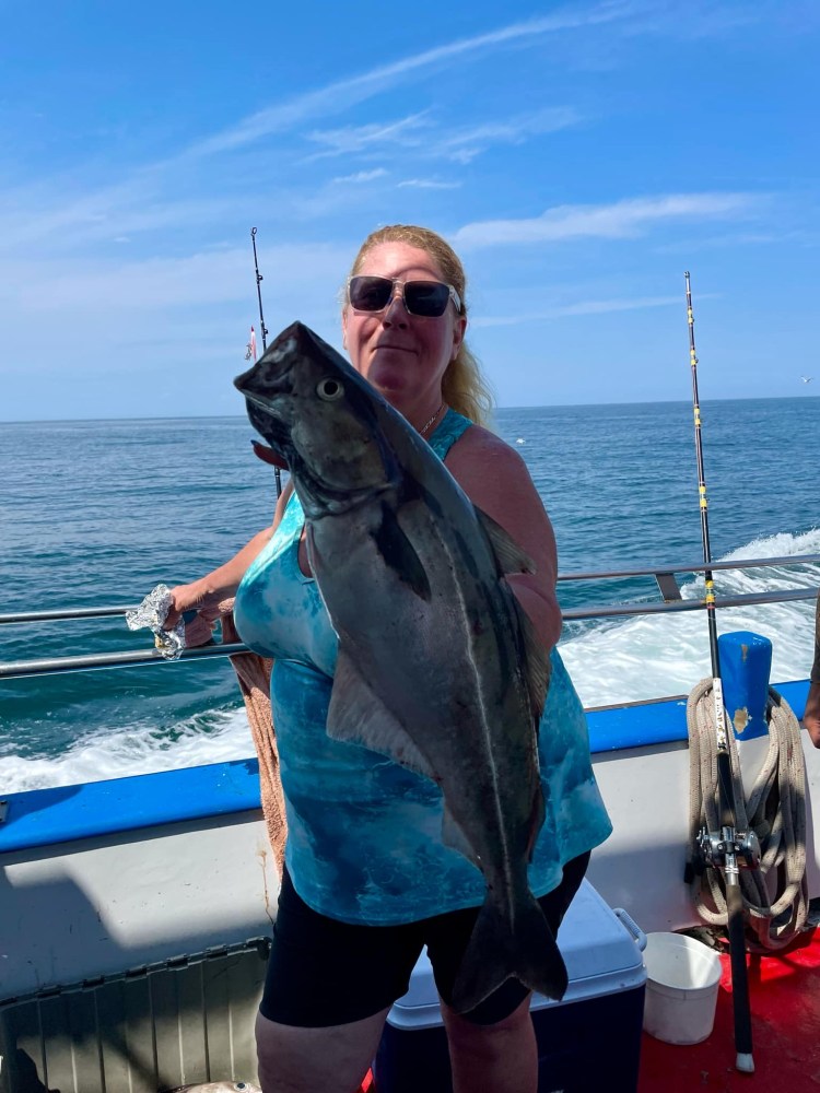 a person holding a fish in the water