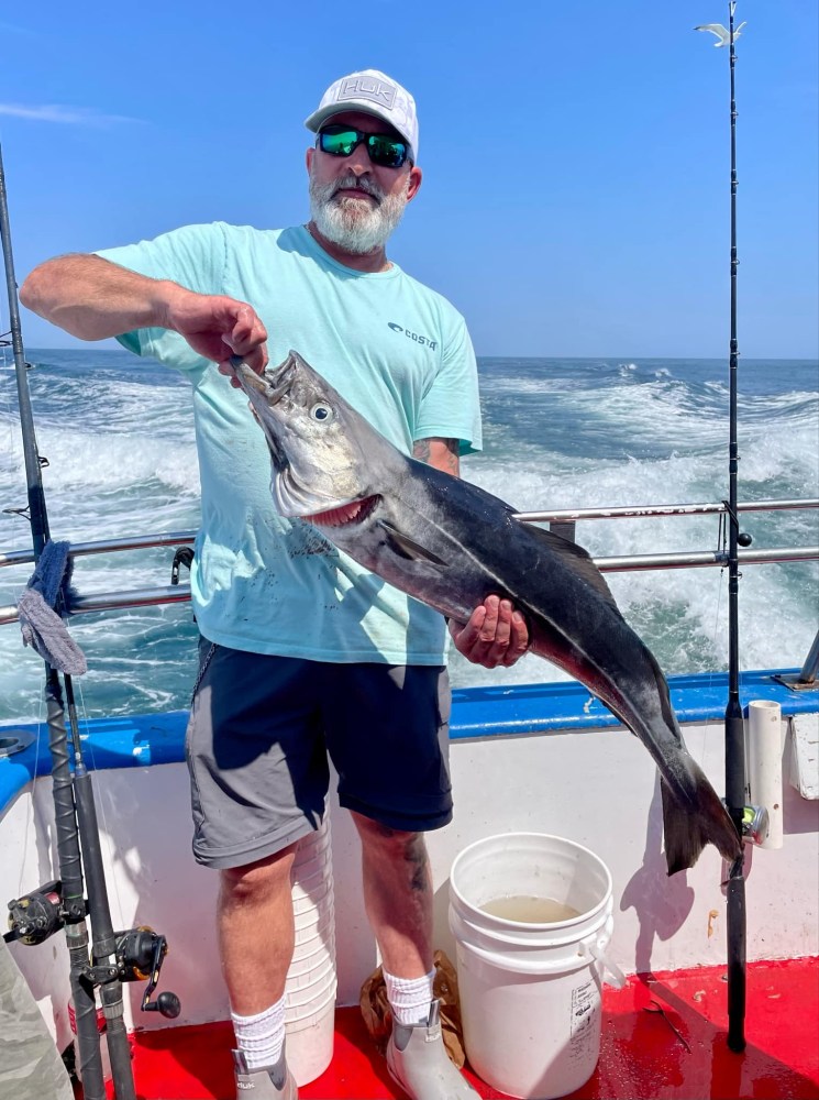 a man holding a fish in the water