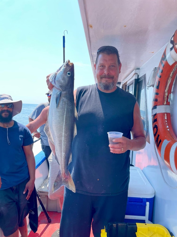 a man holding a fish