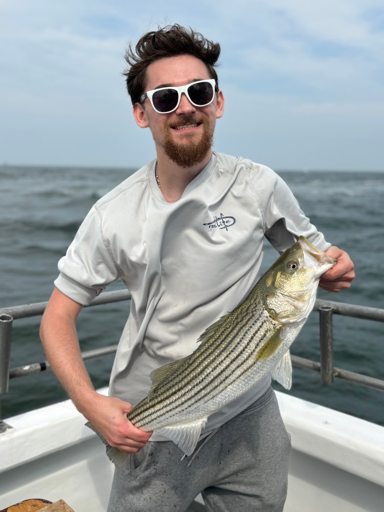 a man holding a fish in the water