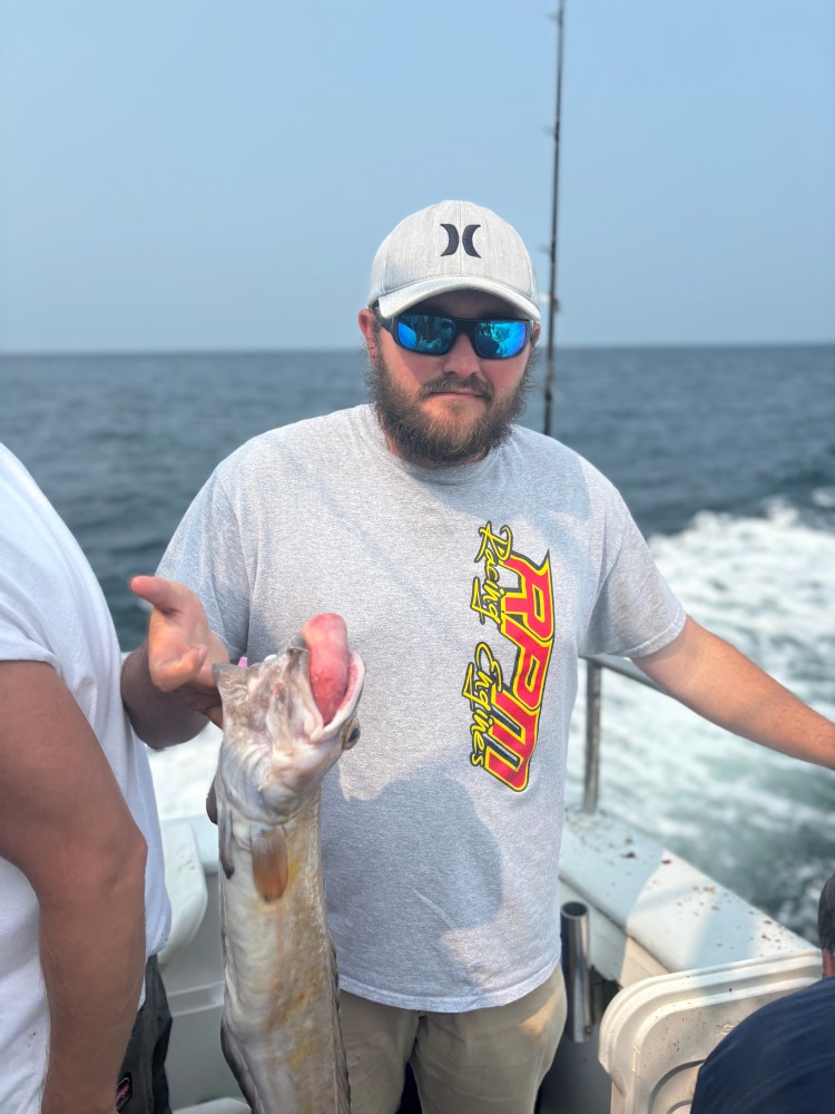 a man holding a fish in the water