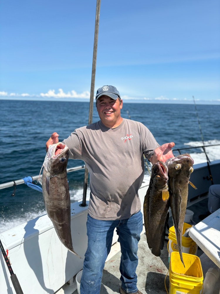 a man holding a fish in the water