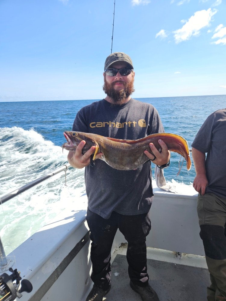 a man holding a fish in the water
