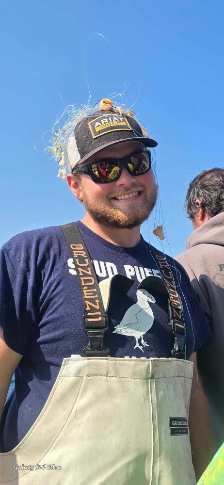 a man wearing a hat and sunglasses