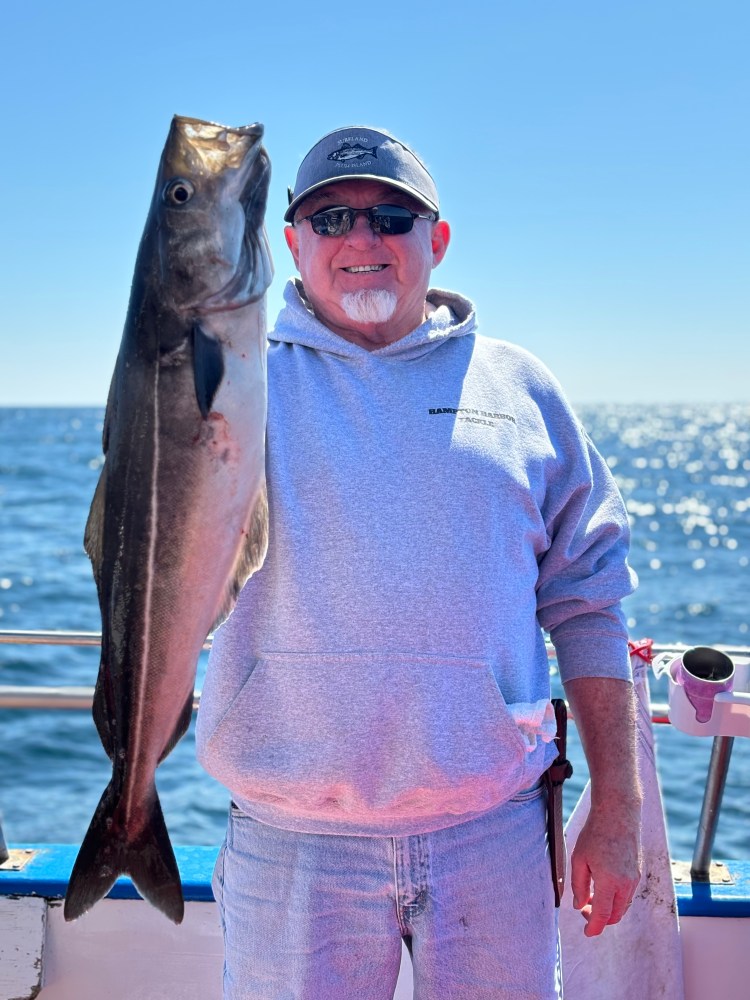 a man holding a fish in the water