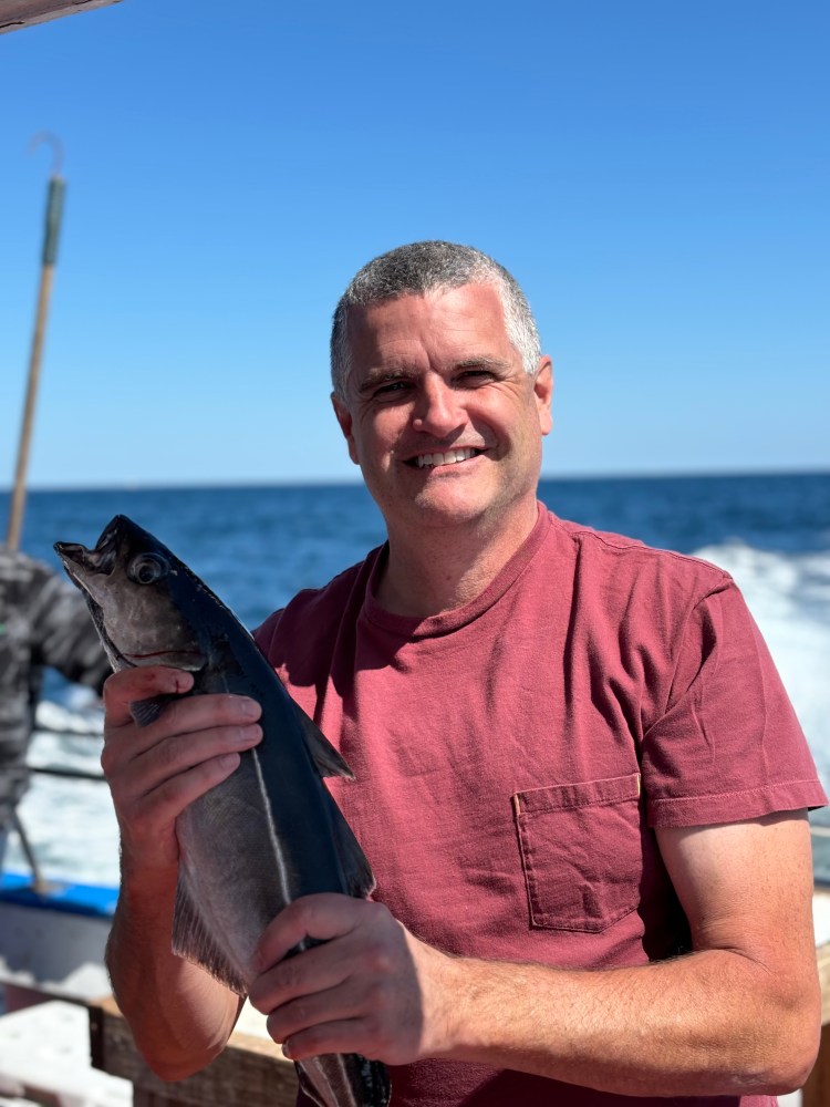 a man holding a fish