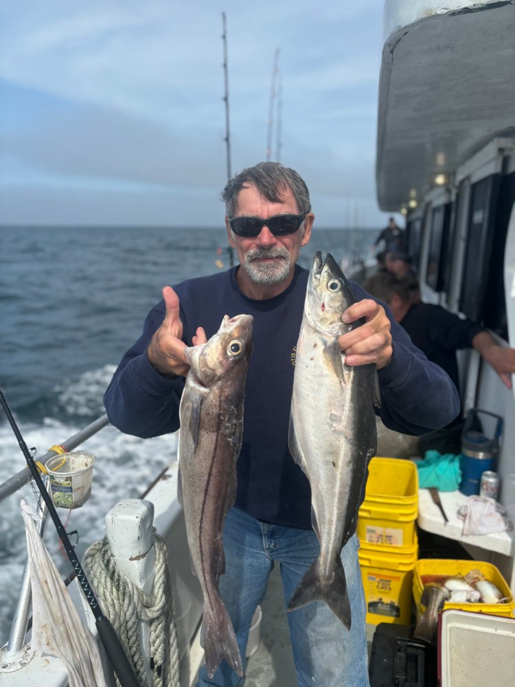 a man holding a fish in the water