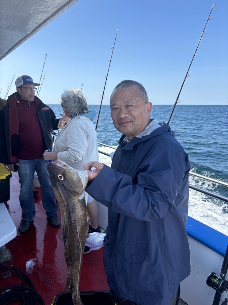 a man holding a fish in the water