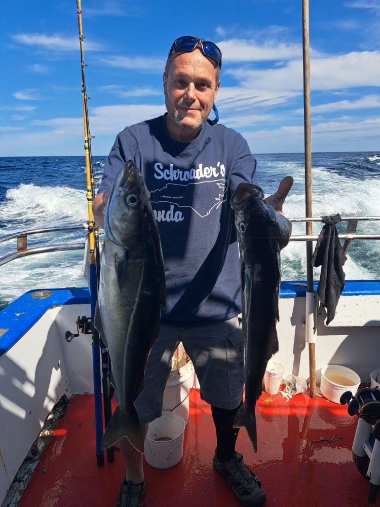 a man holding a fish in the water