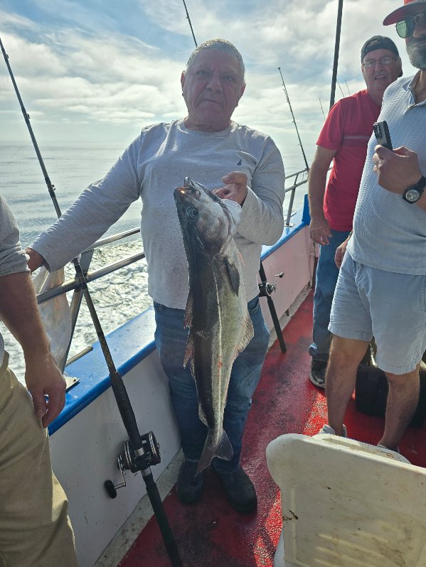 a man holding a fish in the water