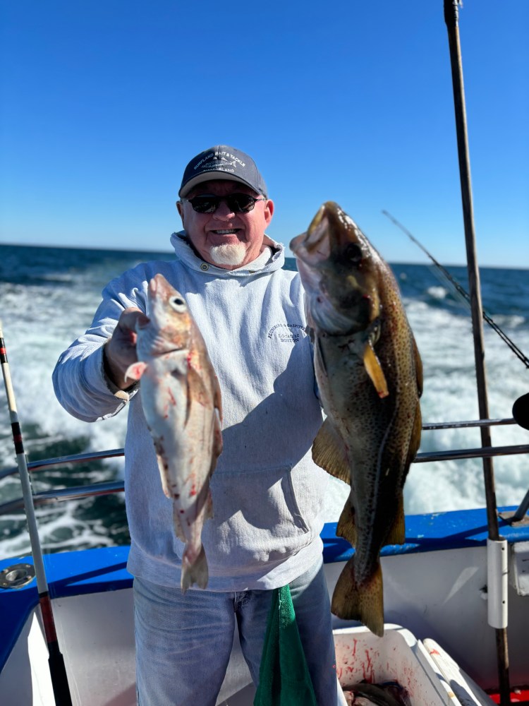 a person holding a fish on a boat