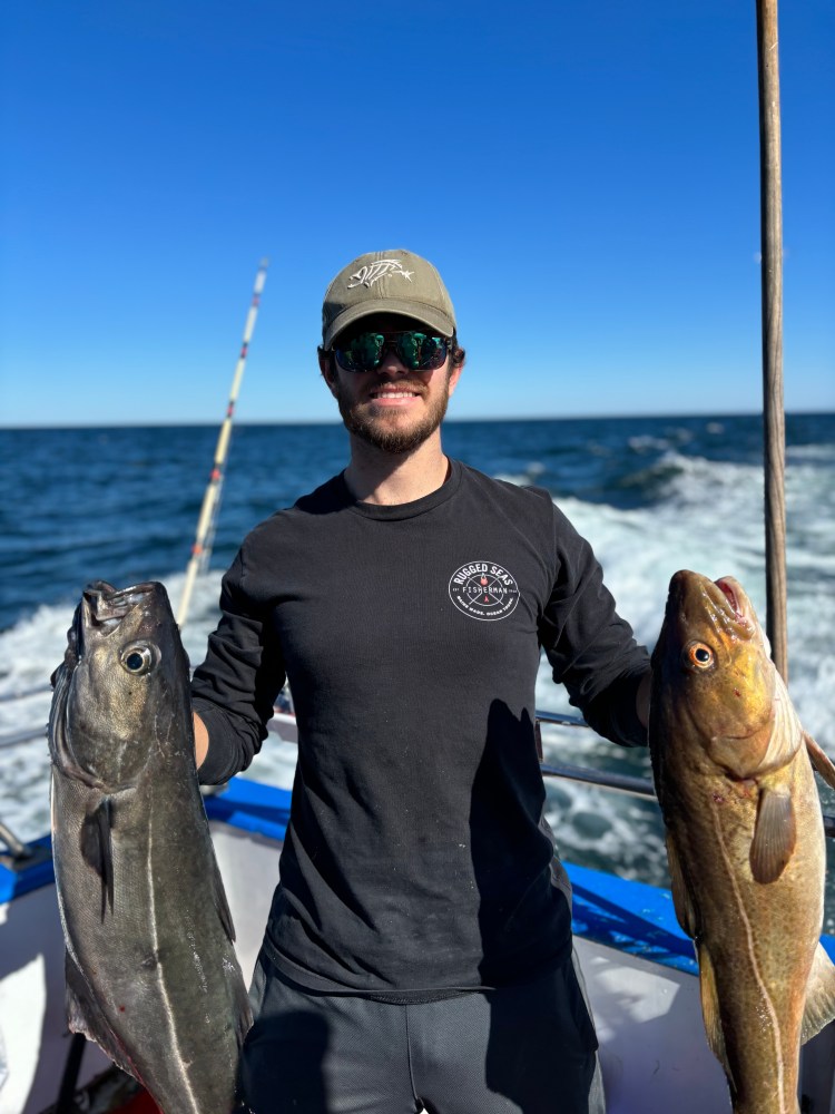 a man holding a fish in the water