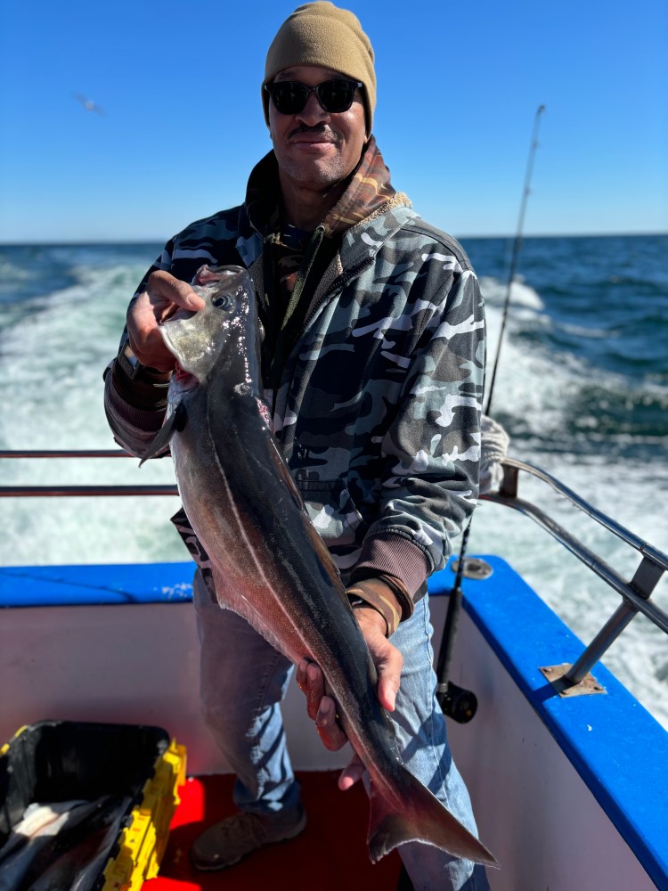 a man holding a fish in the water