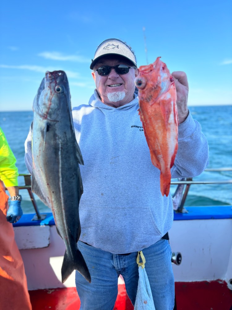 a man holding a fish in the water