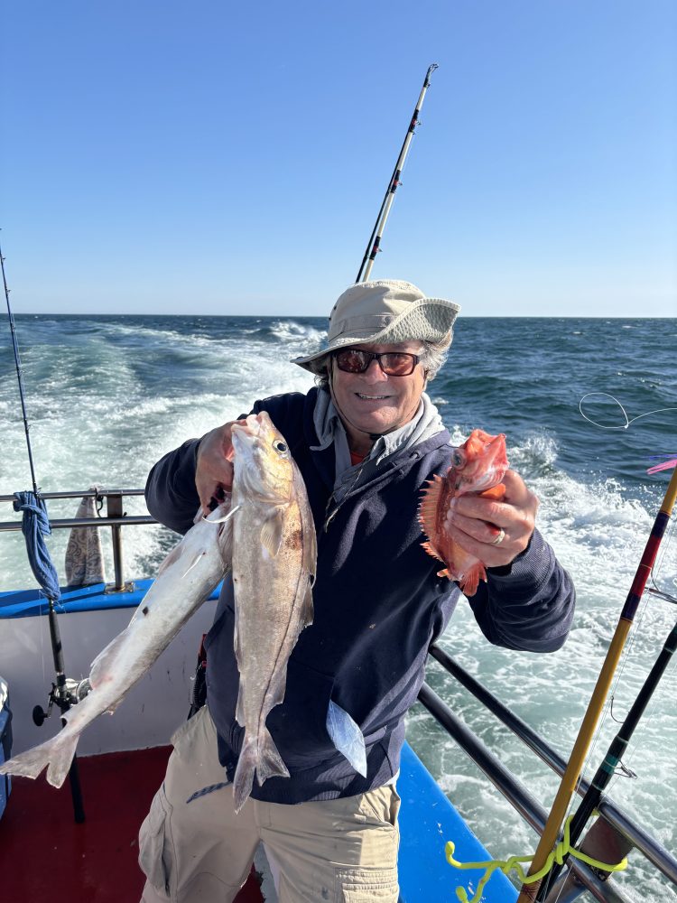 a person holding a fish in the water