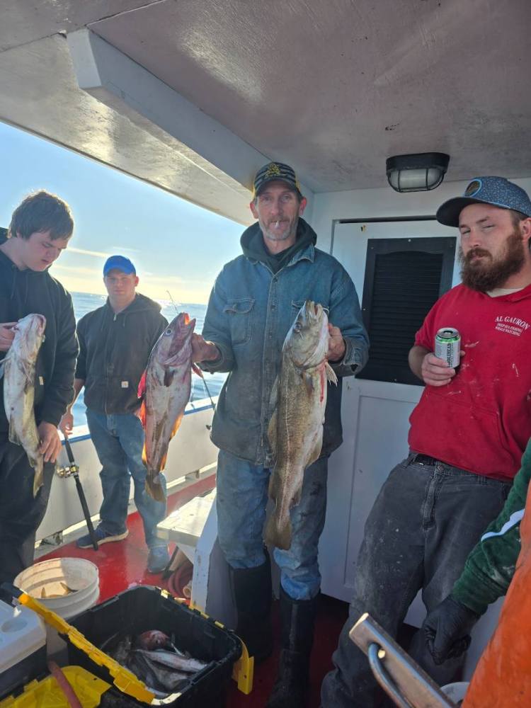 a group of people standing in front of a fish