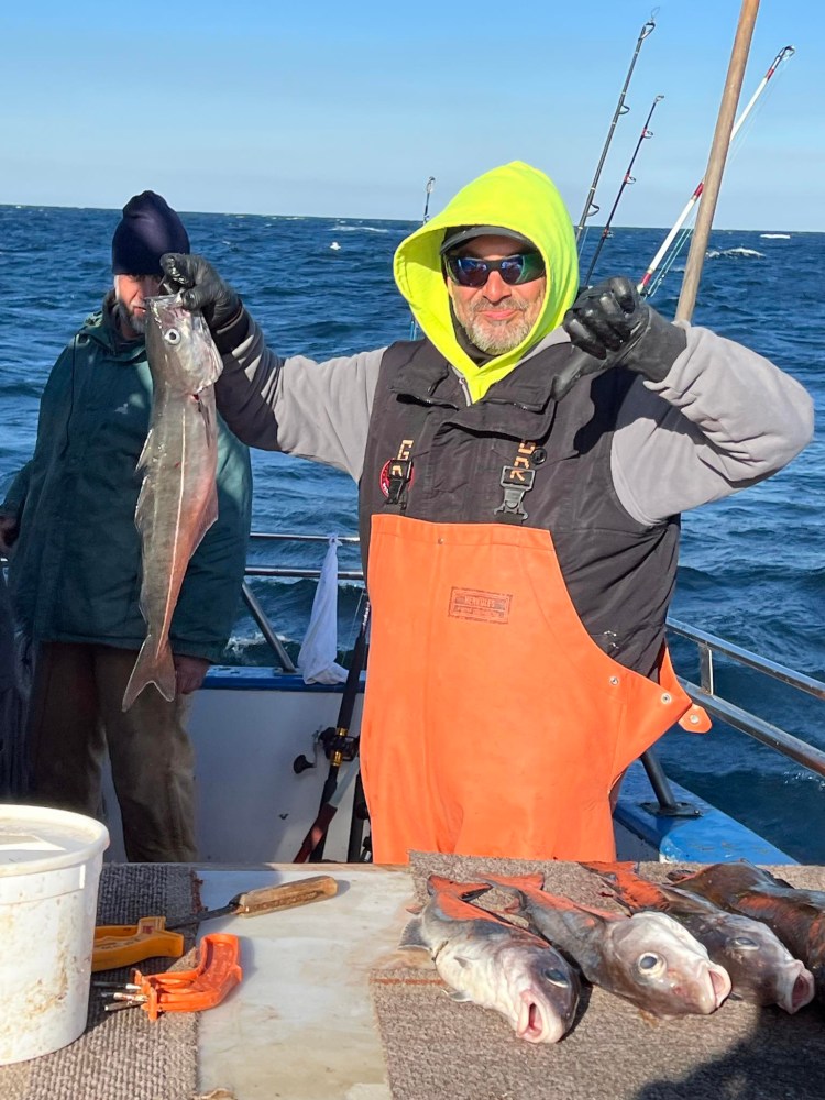 a man holding a fish in the water