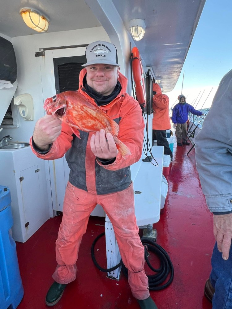 a man holding a fish