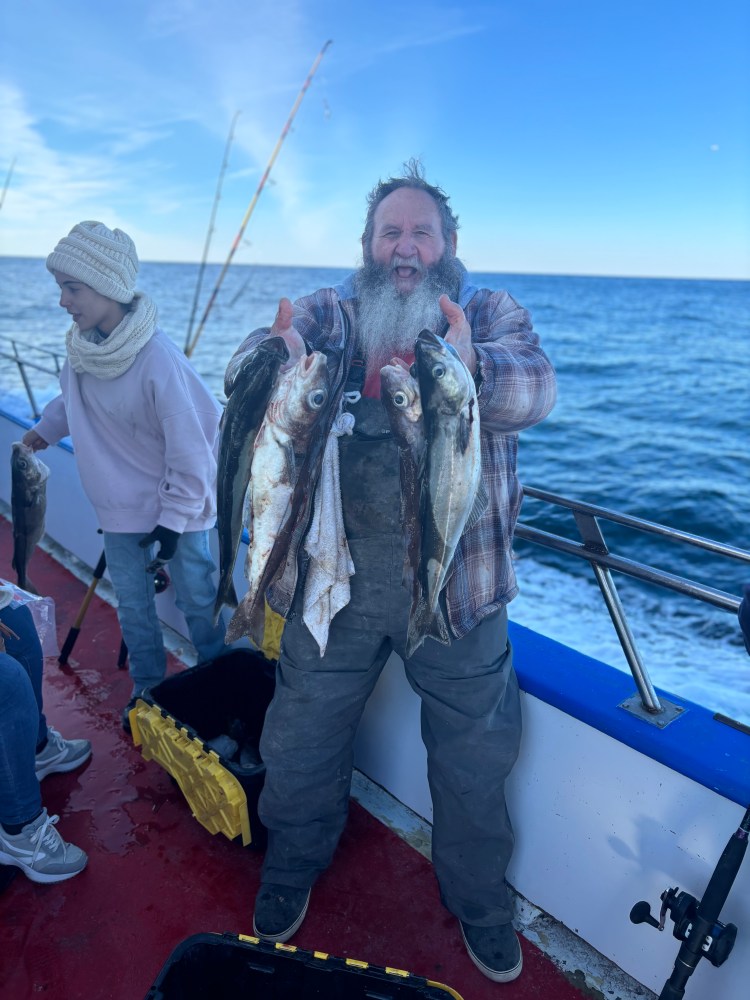 a man holding a fish in the water