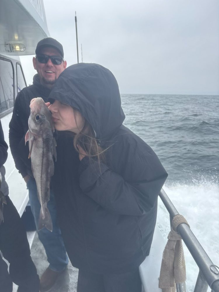 a person holding a fish in the water