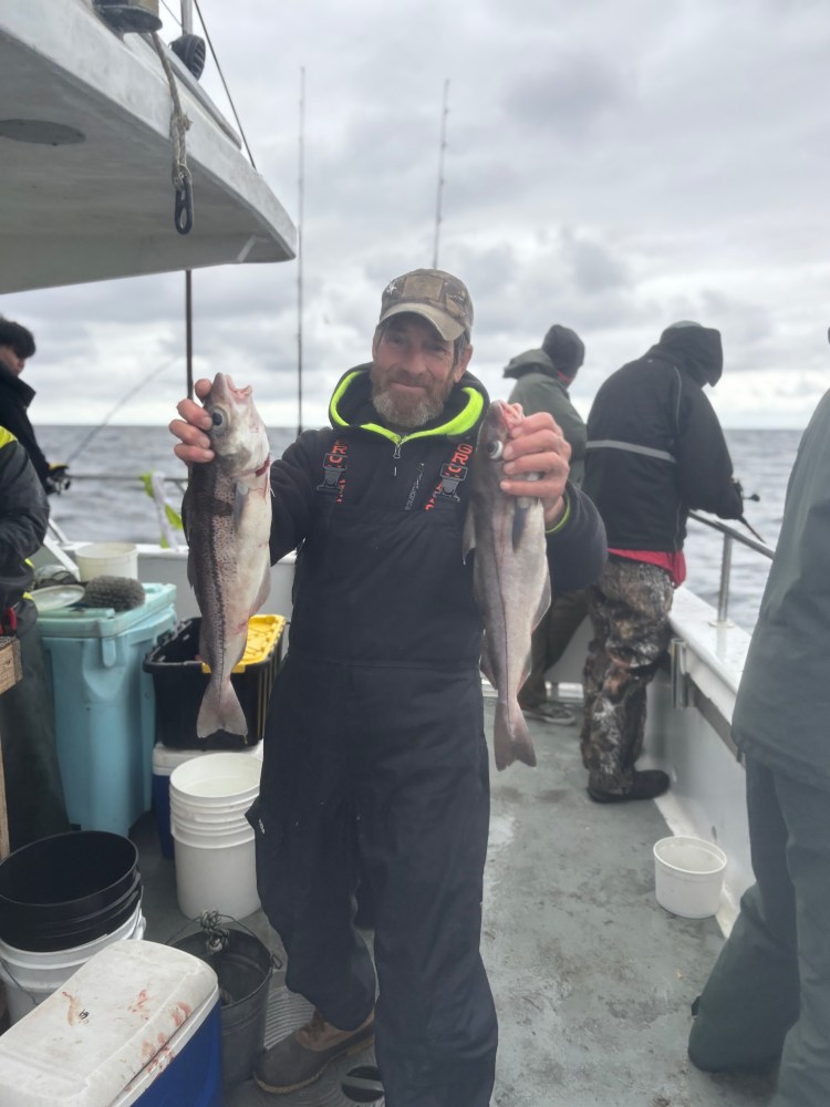a man holding a fish