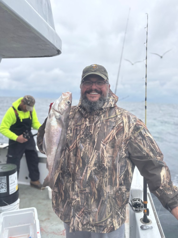 a man holding a fish