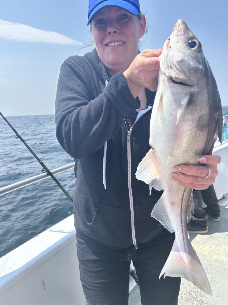 a person holding a fish in the water