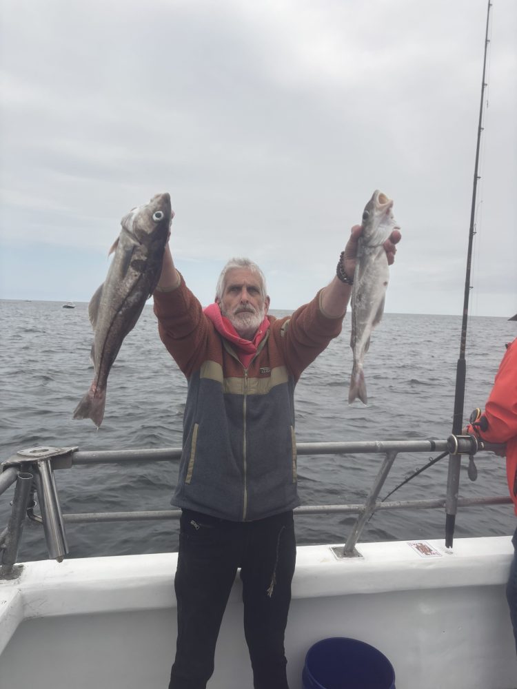 a person holding a fish in the water