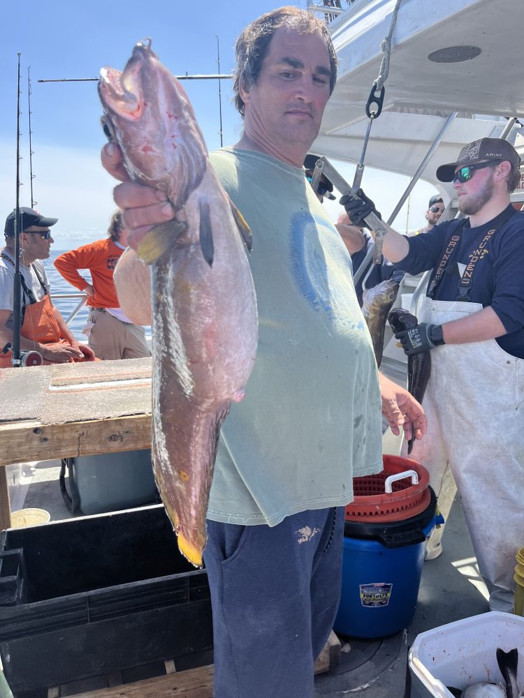 a person holding a fish