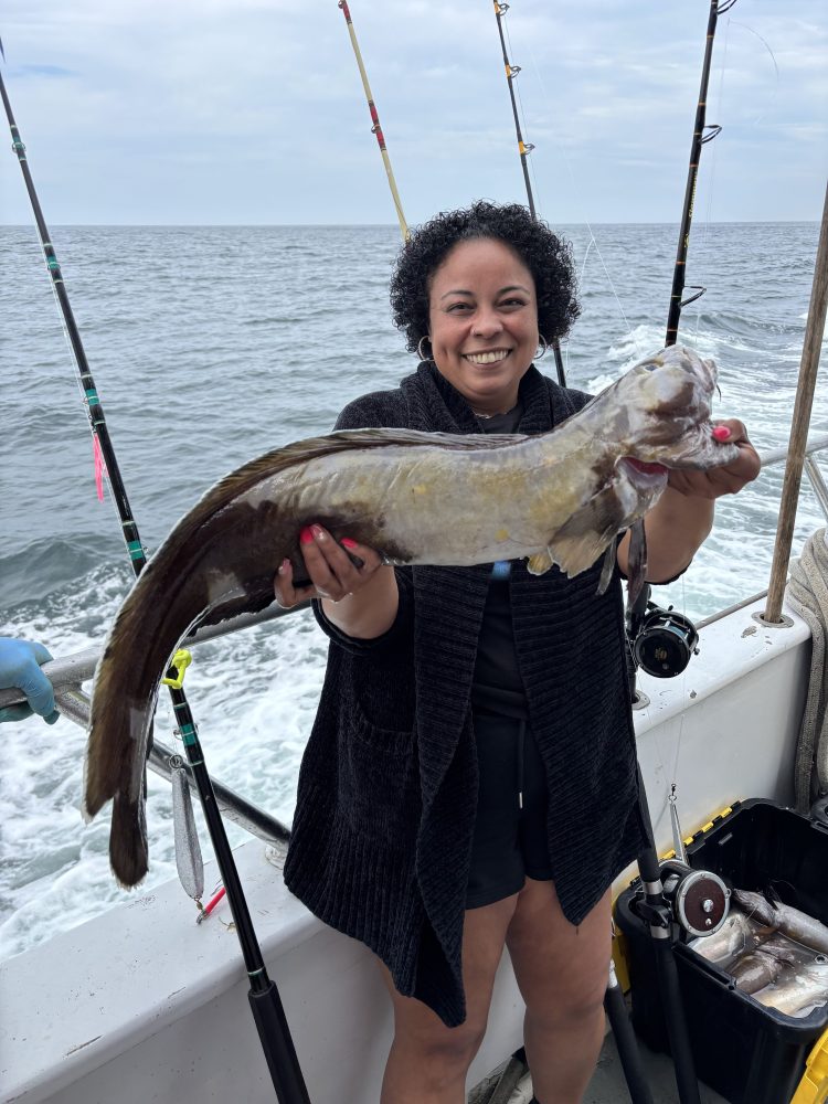 a person holding a fish in the water