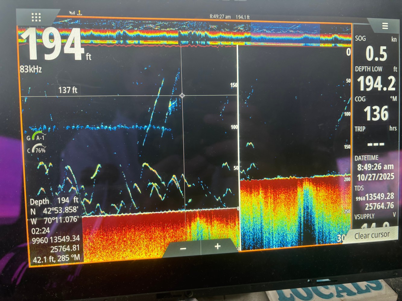 Sonar display showing depth data at 194 feet with colorful graph and numerical readings.