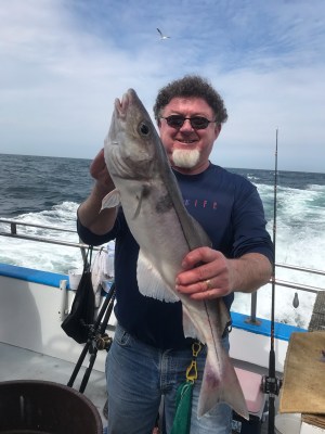a man holding a fish in the water