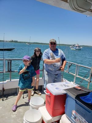 a group of people standing on a boat in the water